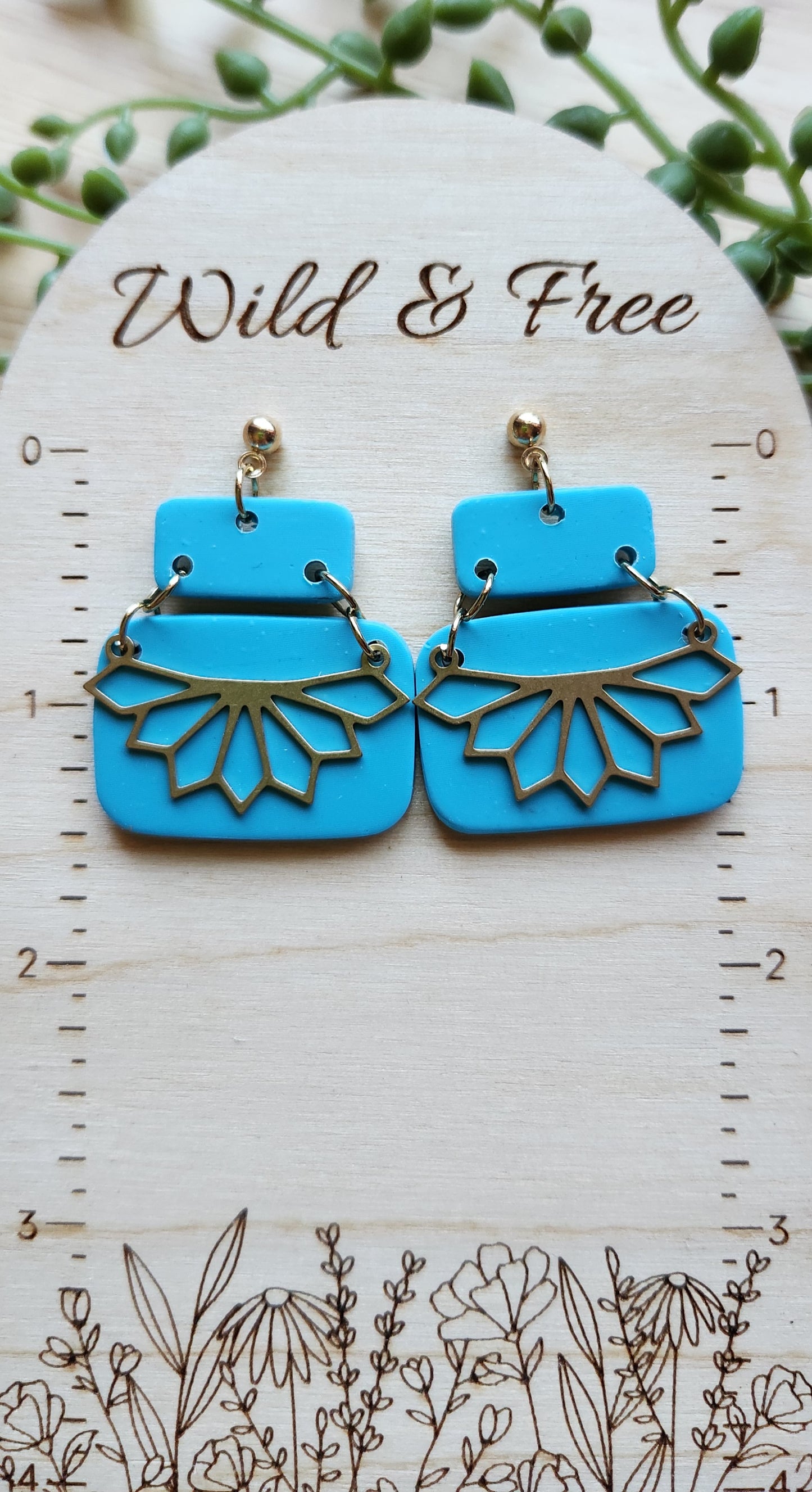 Handmade polymer clay earrings! Stunning turquoise clay color earrings! Two polymer clay rectangles create this earring with gold plated circle stud and jump rings. Bottom rectangle includes a brass shape pointed teardrop cutout half cirle pendant. Matte look, lightweight and approximately 1.5". Please note earrings are made from a handmade polymer clay combination into a slab. Therefore, each earring pair might differ slightly from photo displayed making each pair unique!