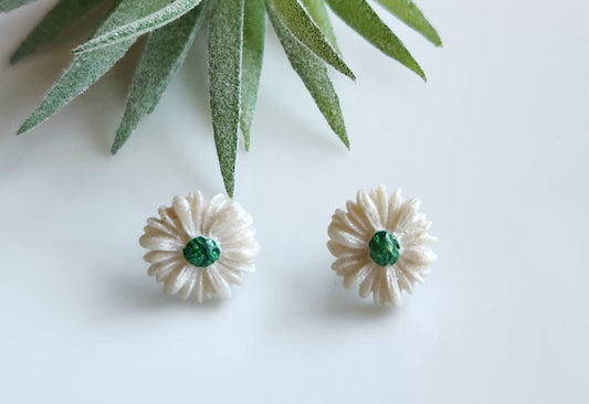 Handmade polymer clay earrings! Daisy shaped flower studs with white pedals and green center circle. Matte look, lightweight and approximately 1/2". Please note earrings are made from a handmade polymer clay combination into a slab. Therefore, each earring pair might differ slightly from photo displayed making each pair unique!