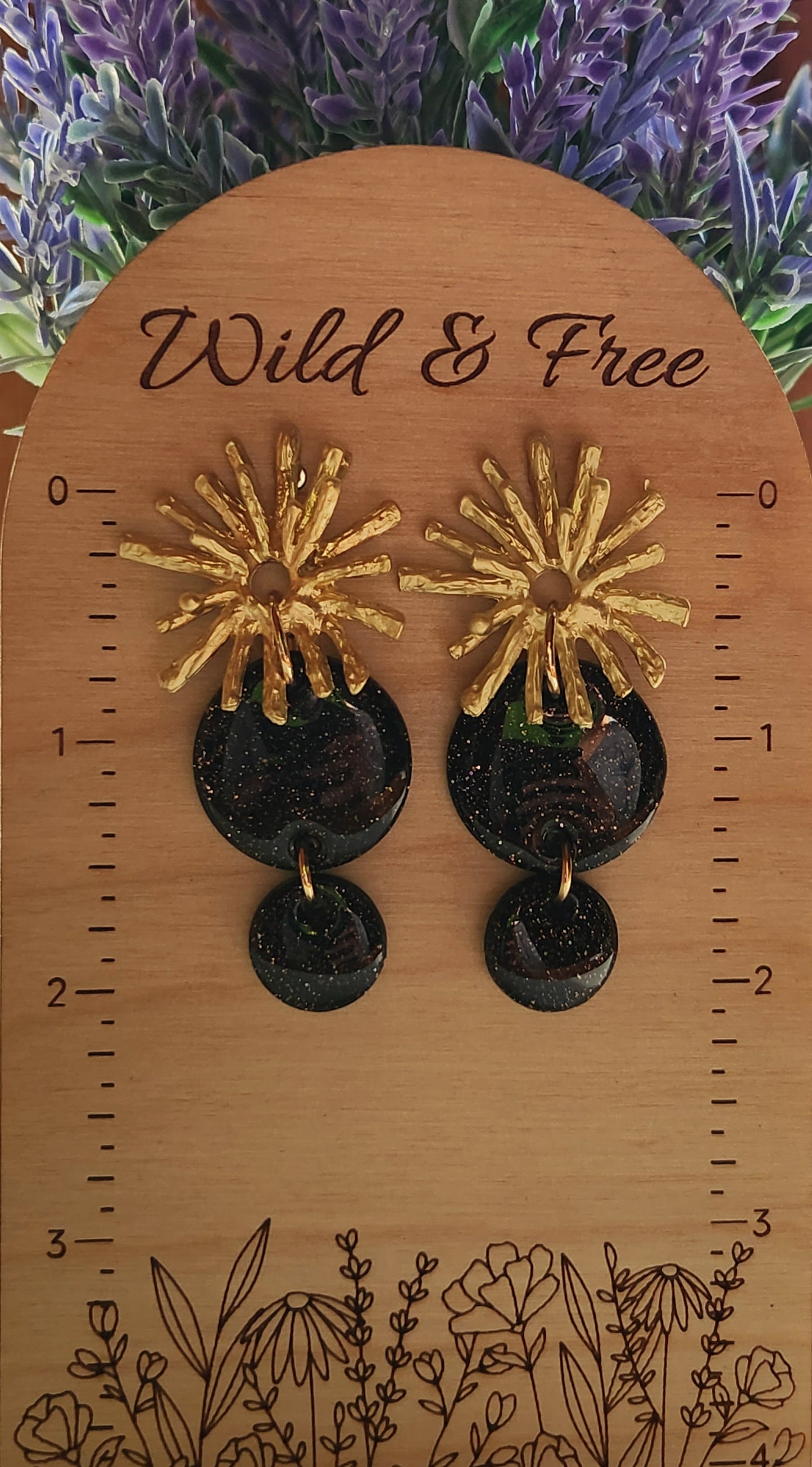 Handmade polymer clay earrings! Lightweight show-stopper earring design! The stunning earring design includes an alloy gold plated floral stud and two black shimmery polymer clay circles. Perfect for any occasion! Meant to stand out! Lightweight, with resin for a glossy look, and approximately 2" long.