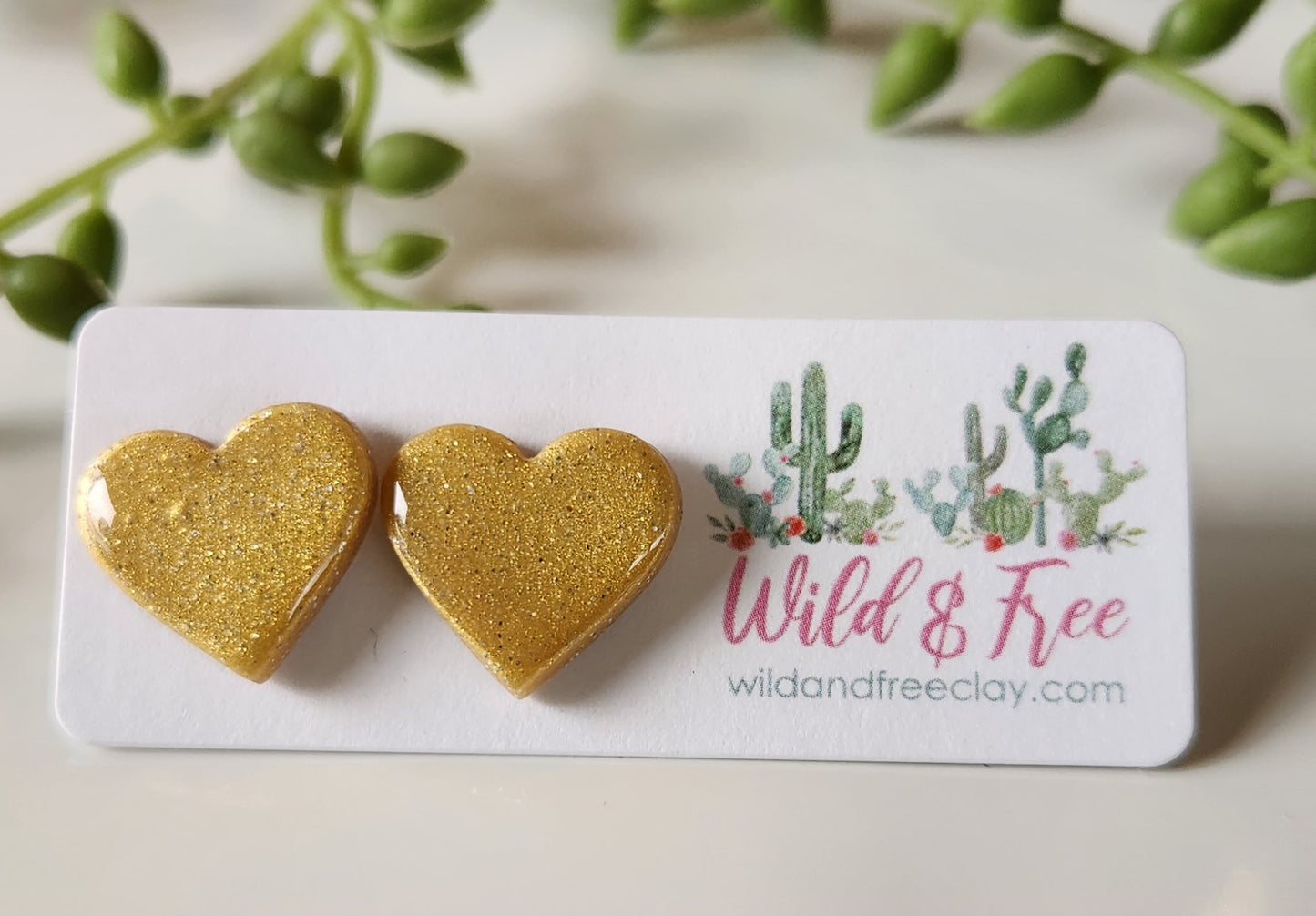 Handmade polymer clay heart earrings! Perfect shade of shimmer gold form these heart shape polymer clay earrings. Lightweight and with resin for a glossy look. Approximately .5" long.