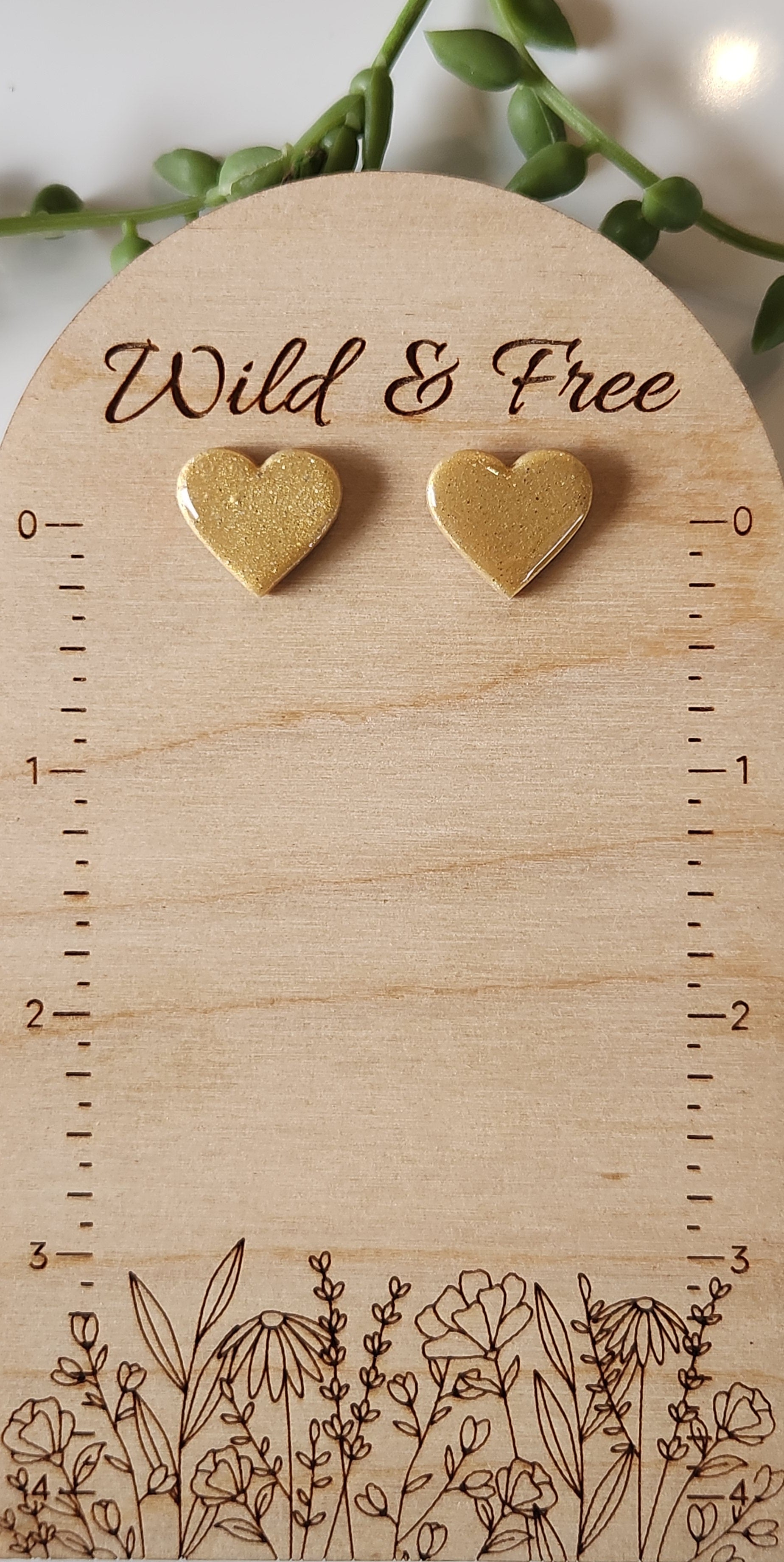 Handmade polymer clay heart earrings! Perfect shade of shimmer gold form these heart shape polymer clay earrings. Lightweight and with resin for a glossy look. Approximately .5" long.