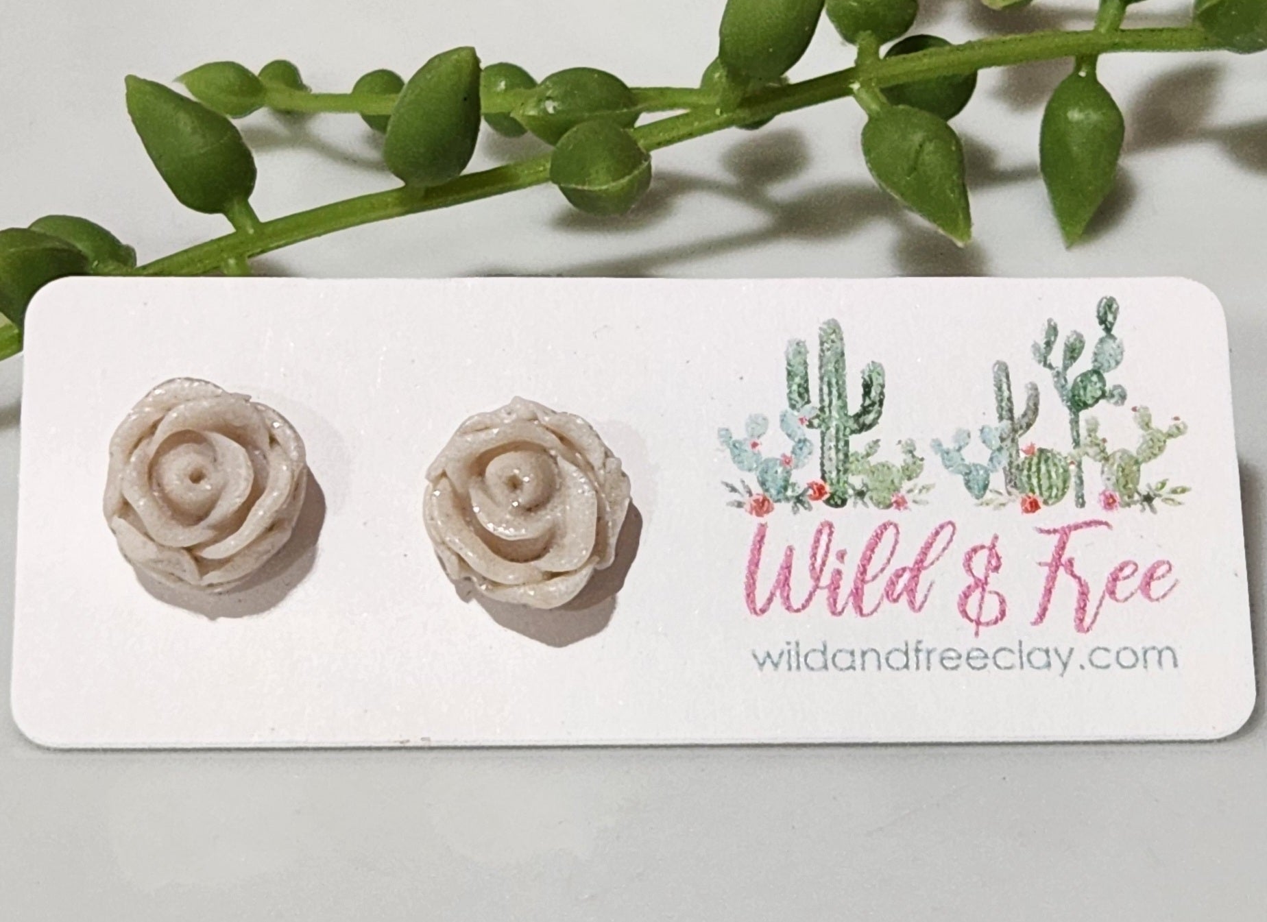 Handmade polymer clay earrings! Pefect sized studs of peal clay color designed as a rose. Lightweight and approximately .5" long.