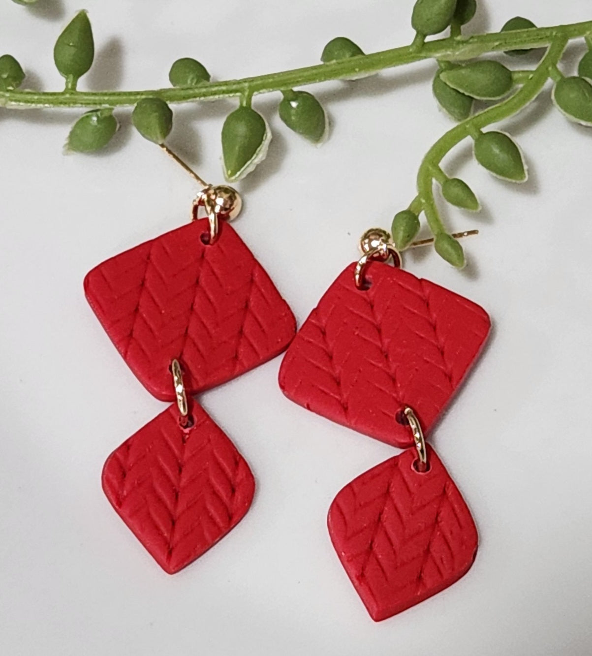 Handmade polymer clay earrings! These beautiful red clay color earrings consist of a gold plated circle stud and two diamond textured clay pieces. Perfect for any season, lightweight and approximately 2" long.