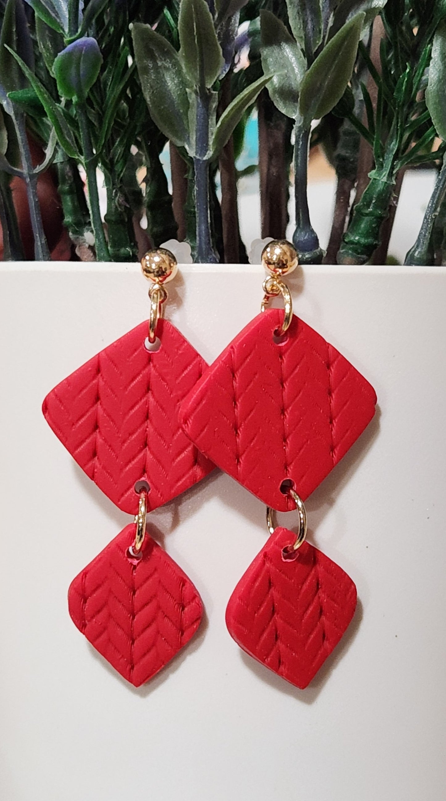 Handmade polymer clay earrings! These beautiful red clay color earrings consist of a gold plated circle stud and two diamond textured clay pieces. Perfect for any season, lightweight and approximately 2" long.