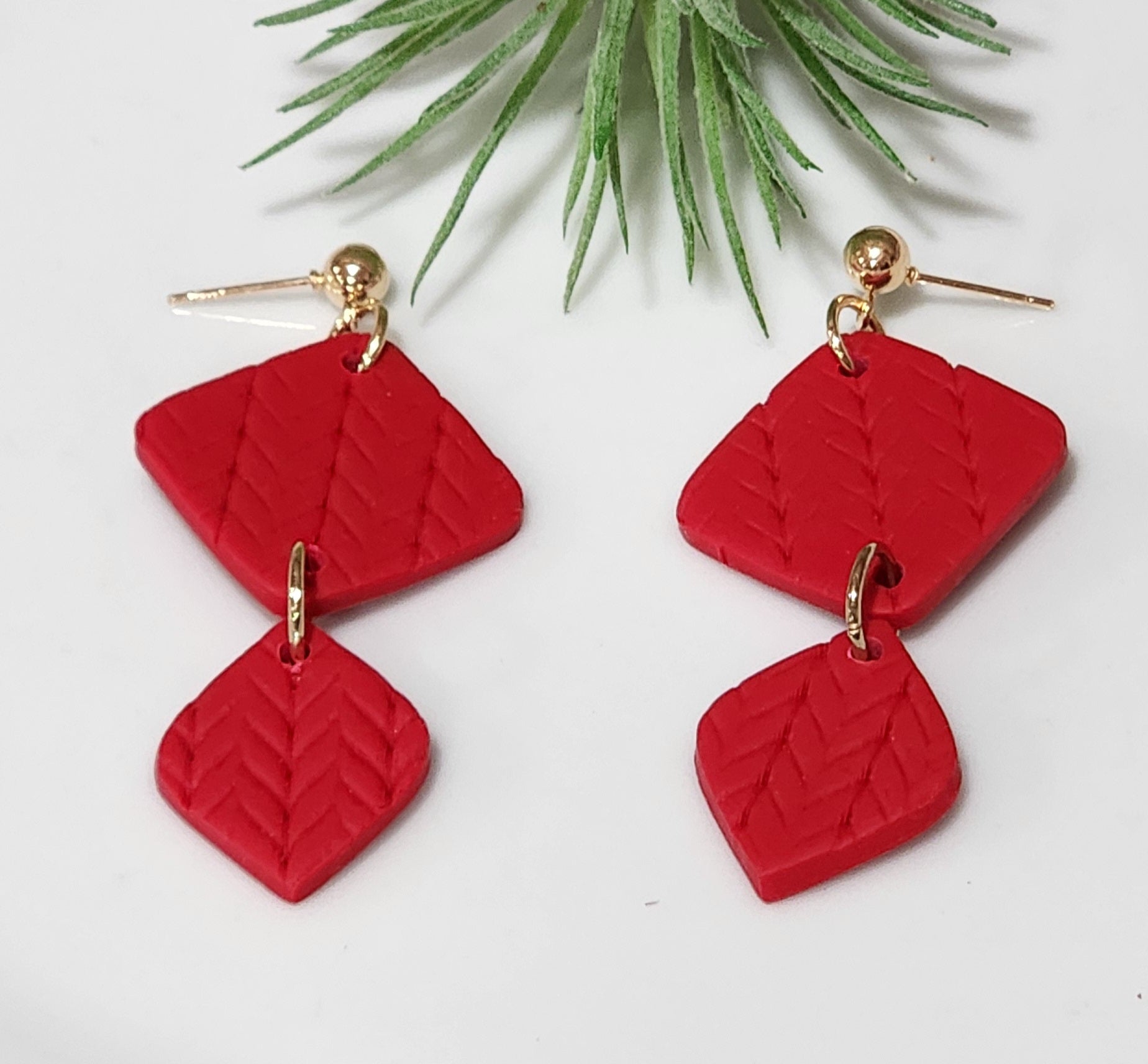 Handmade polymer clay earrings! These beautiful red clay color earrings consist of a gold plated circle stud and two diamond textured clay pieces. Perfect for any season, lightweight and approximately 2" long.