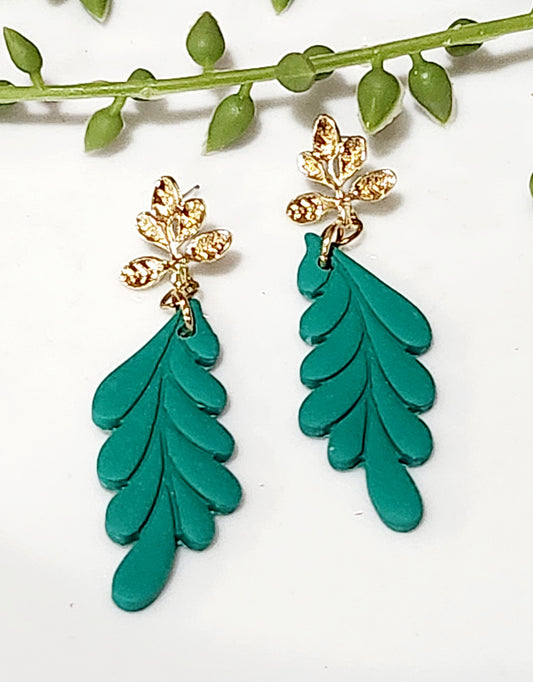 Handmade polymer clay earrings! This beautiful dangle consist of a gold plated leaf stud with a cascading pedal green clay blend. Earrings are lightweight, matte and approximately 2.5" long.