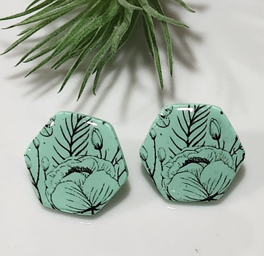 Handmade polymer clay earrings! Hexagon shape stud with mint background clay and black floral design paint. These stud earrings are perfect for any outfit and a staple accessory item for all. Studs are approximately 1" long and with resin for a glossy look.