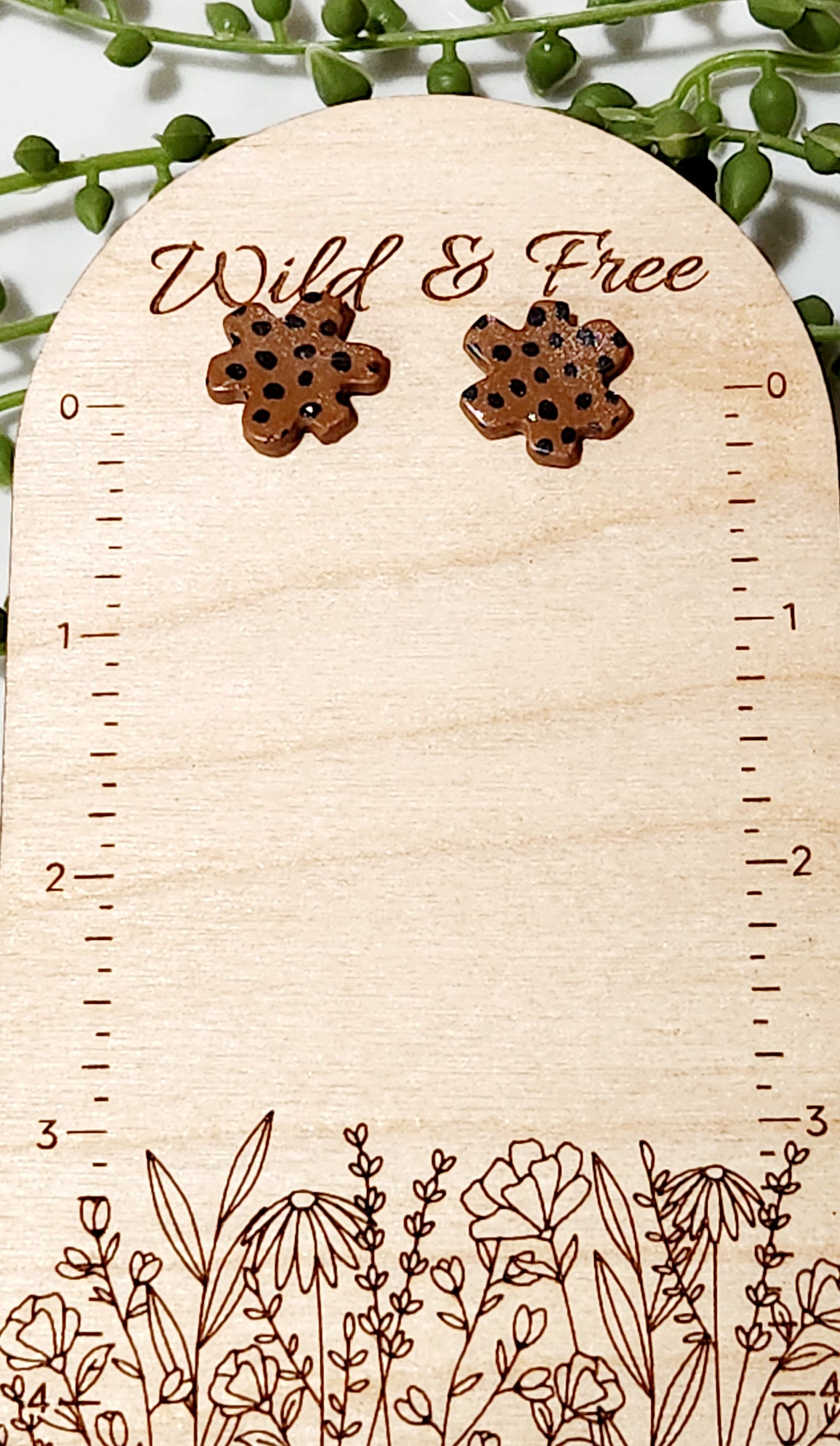 Handmade polymer clay earrings! Floral shape stud with brown background clay and balck polka dot paint. These stud earrings are perfect for any outfit and a staple accessory item for all. Studs are approximately .5" long and with resin for a glossy look.