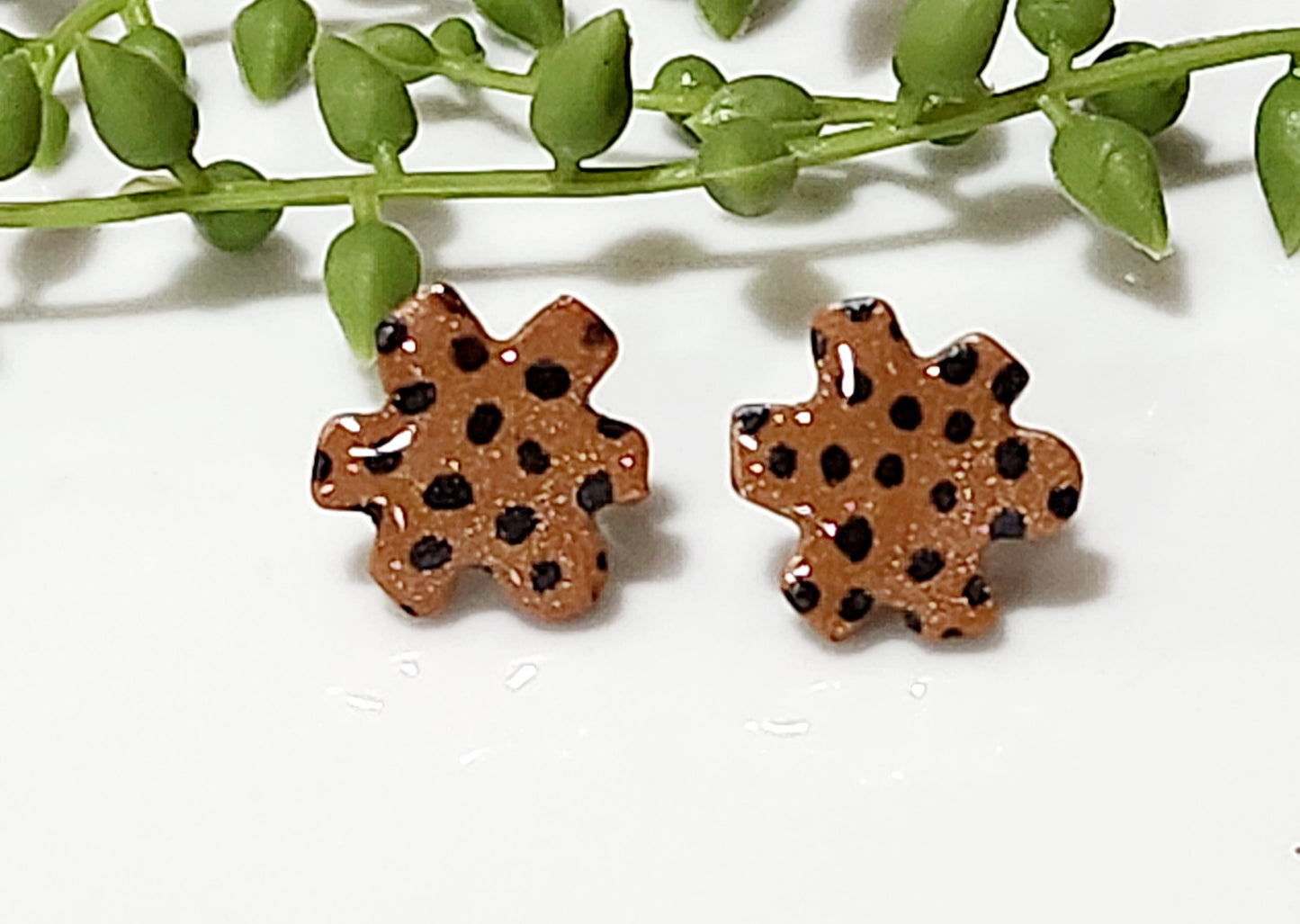 Handmade polymer clay earrings! Floral shape stud with brown background clay and balck polka dot paint. These stud earrings are perfect for any outfit and a staple accessory item for all. Studs are approximately .5" long and with resin for a glossy look.