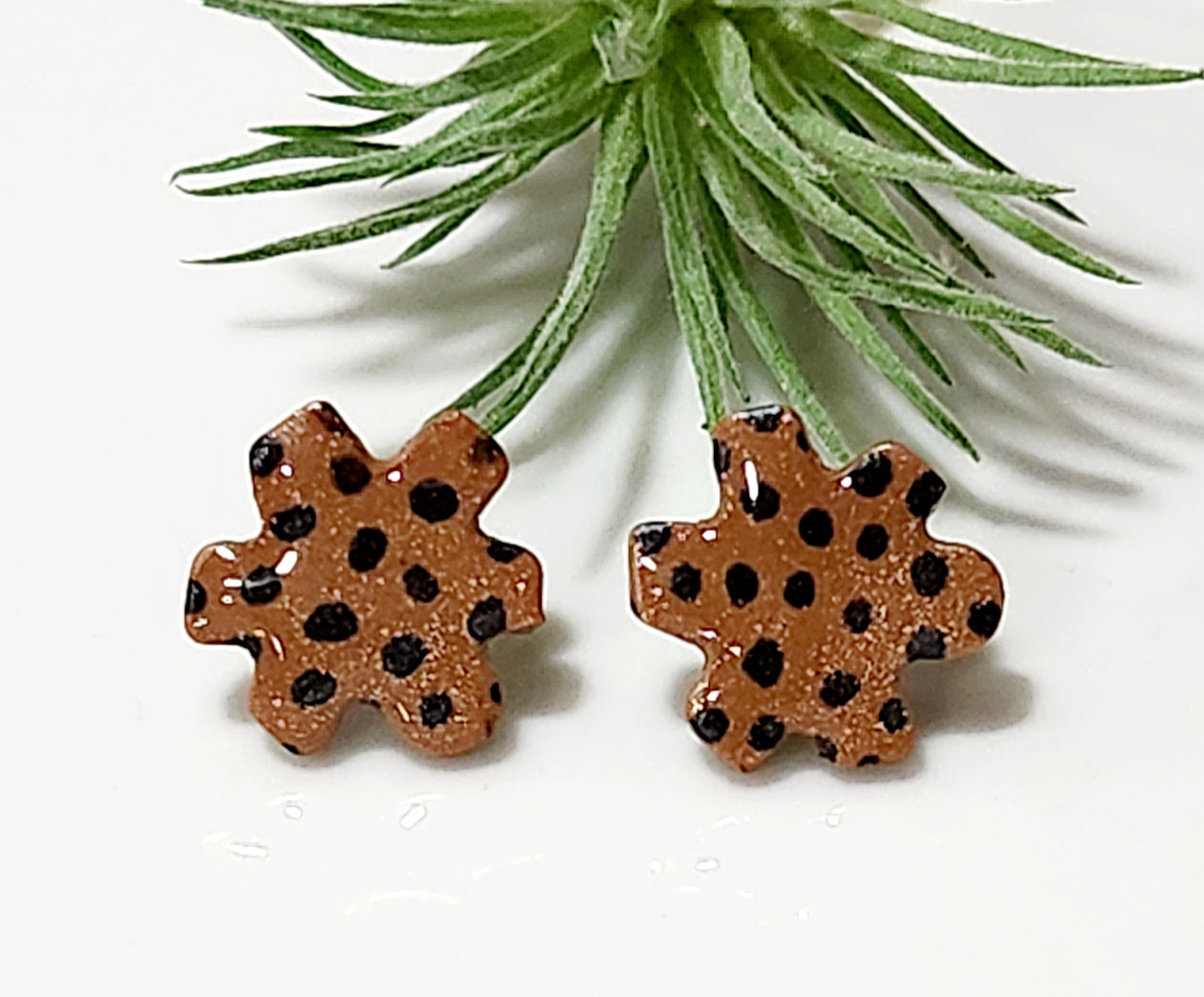 Handmade polymer clay earrings! Floral shape stud with brown background clay and balck polka dot paint. These stud earrings are perfect for any outfit and a staple accessory item for all. Studs are approximately .5" long and with resin for a glossy look.