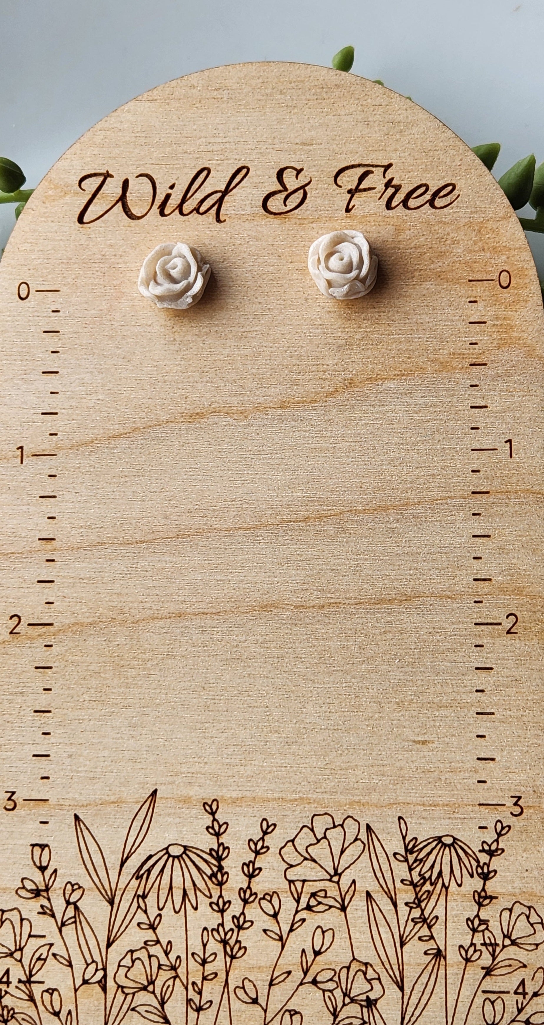 Handmade polymer clay earrings! Pefect sized studs of peal clay color designed as a rose. Lightweight and approximately .5" long.