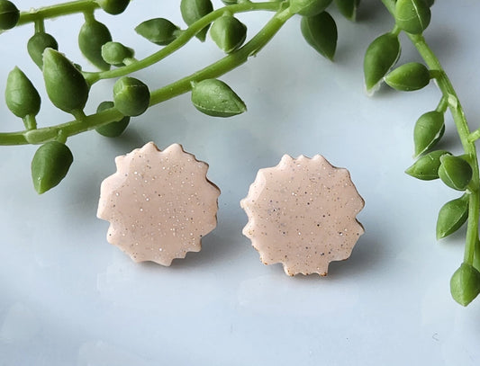 Handmade polymer clay earrings! These circular earring studs are made up of nude color clay blend with shimmer throughout! They are pefect for any color outfit! Earrings are lightweight, with resin for a glossy look and approximately .5" long.