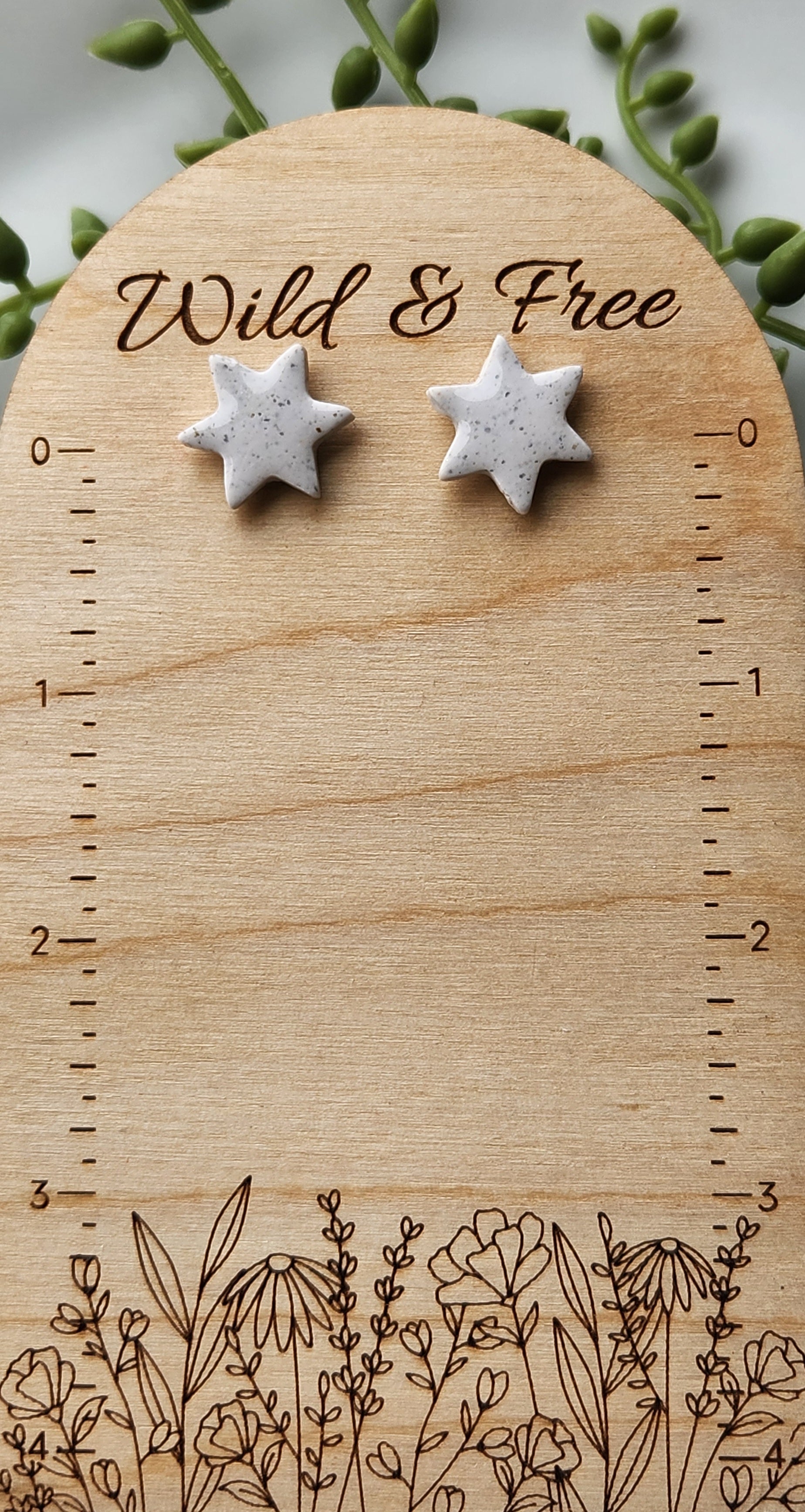 Handmade polymer clay earrings! Star shape stud with white background clay and black spekled dots. These stud earrings are perfect for any outfit and a staple accessory item for all. Studs are approximately .5" long and with resin for a glossy look.