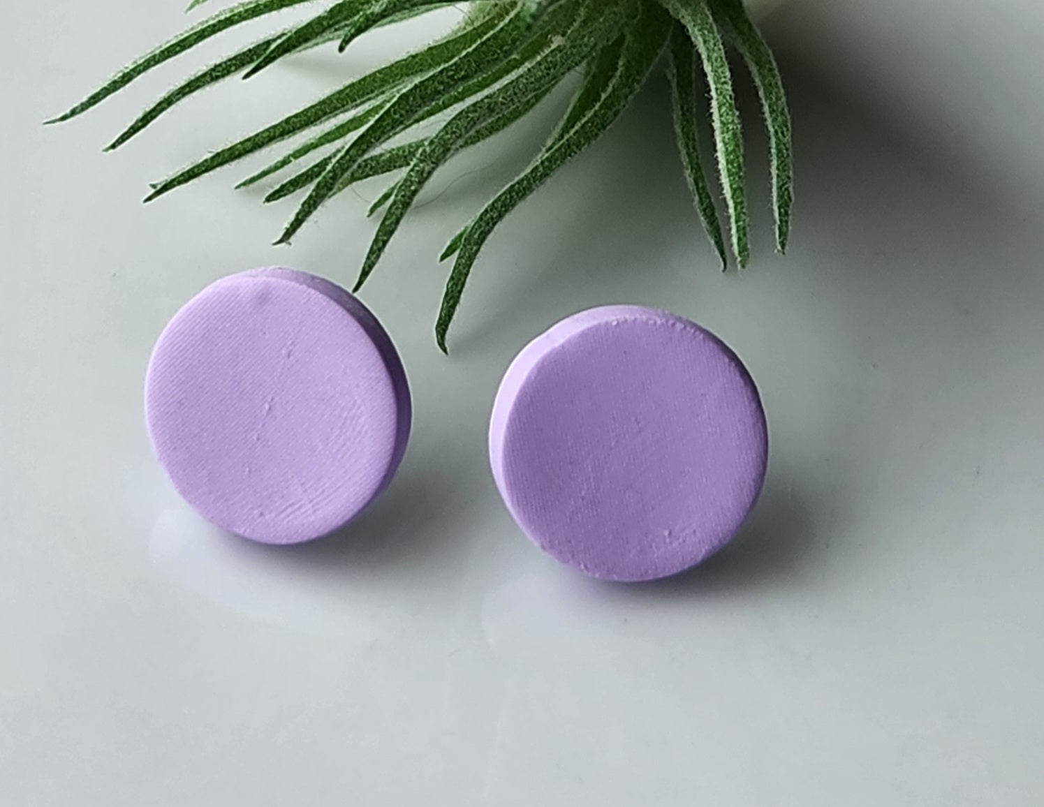 Handmade polymer clay earrings! These earring studs are a beautiful lavendar clay color with a circle shape. They are perfectly sized and match with any outfit. Earring studs are lightweight, matte look and approximately .5" long.