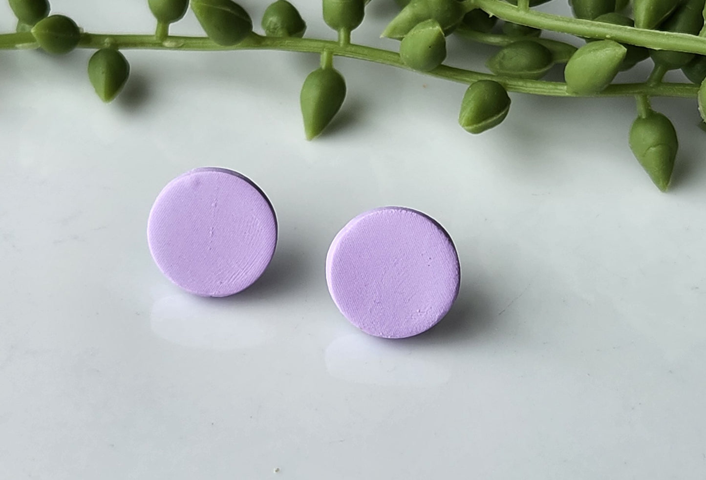 Handmade polymer clay earrings! These earring studs are a beautiful lavendar clay color with a circle shape. They are perfectly sized and match with any outfit. Earring studs are lightweight, matte look and approximately .5" long.