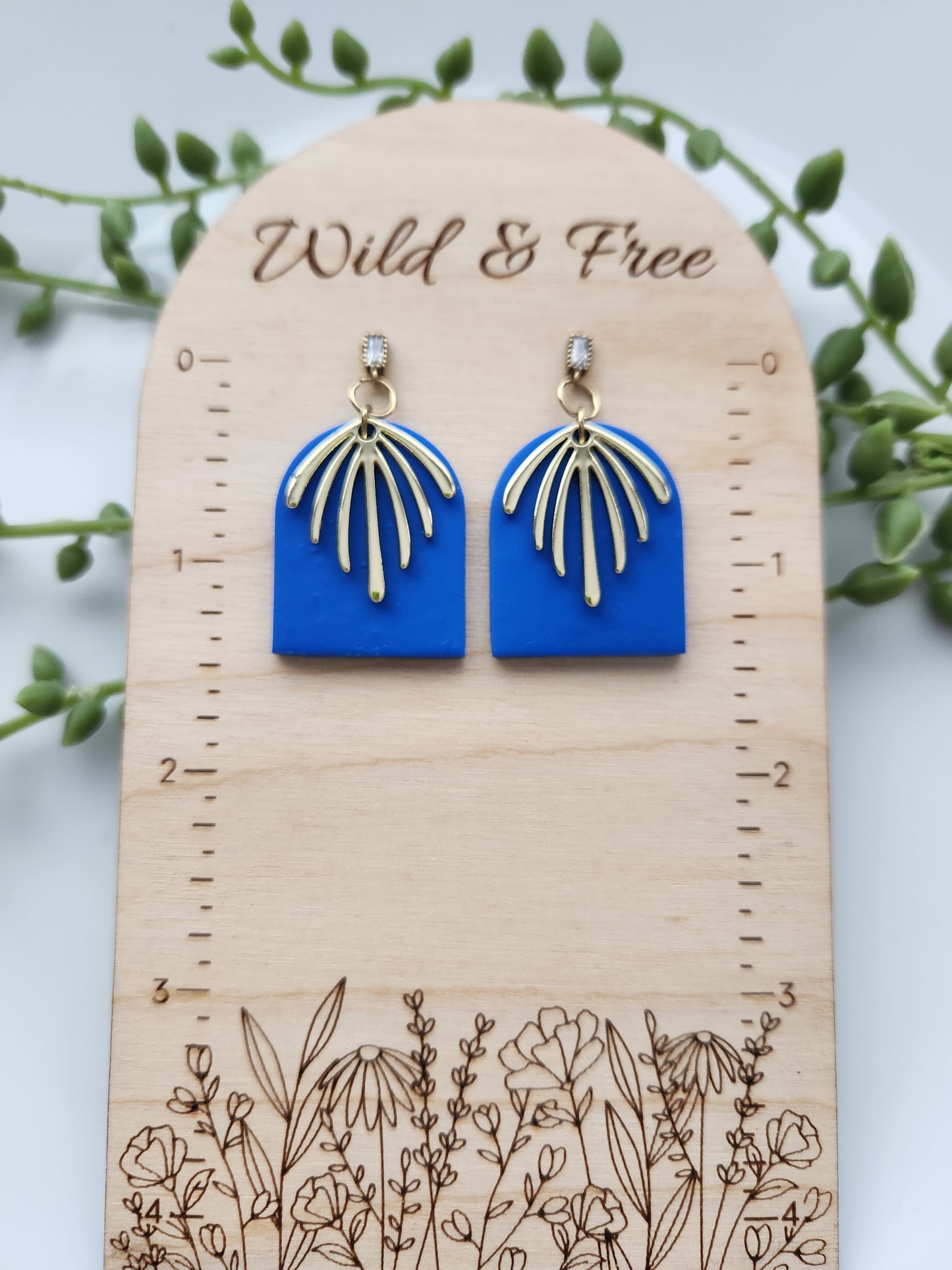 Handmade rich blue polymer clay earrings! This bright blue color is my favorite! These dangle earrings are of a dome shape with a gold-plated charm consisting of 7 lines facing down. A sterling silver needle zircon earring post completes this earring design. They are sure to stand out, lightweight, and approximately 2" long.