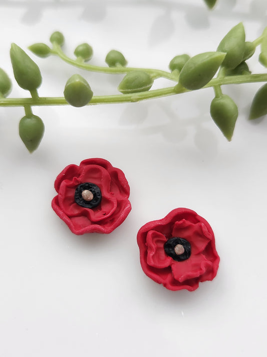 Handmade polymer clay earrings! These beautiful studs are made from red clay in a poppy flower design. They are a unique and perfect touch to any outfit. Lightweight, matte, and approximately .5" long.