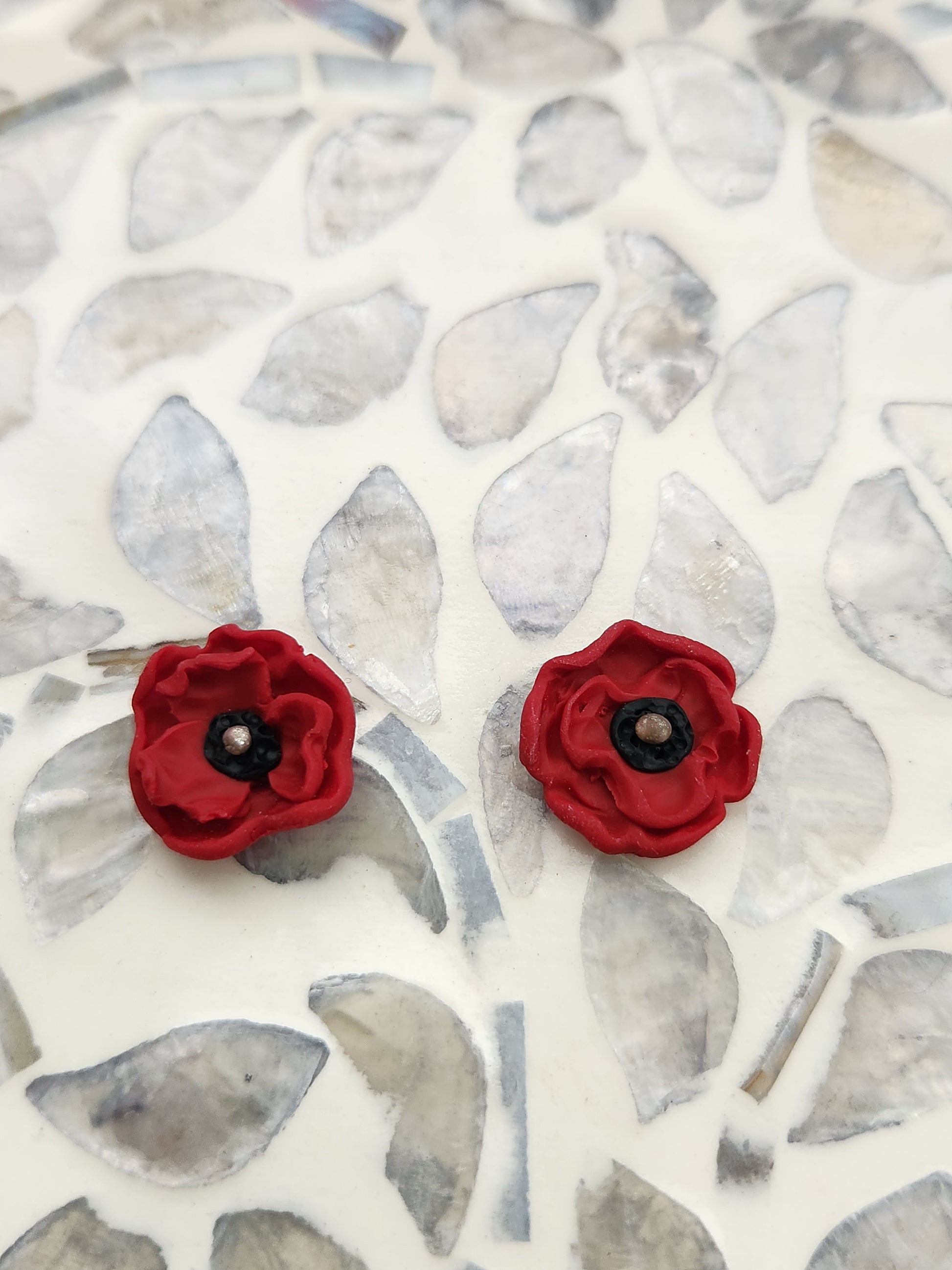 Handmade polymer clay earrings! These beautiful studs are made from red clay in a poppy flower design. They are a unique and perfect touch to any outfit. Lightweight, matte, and approximately .5" long.