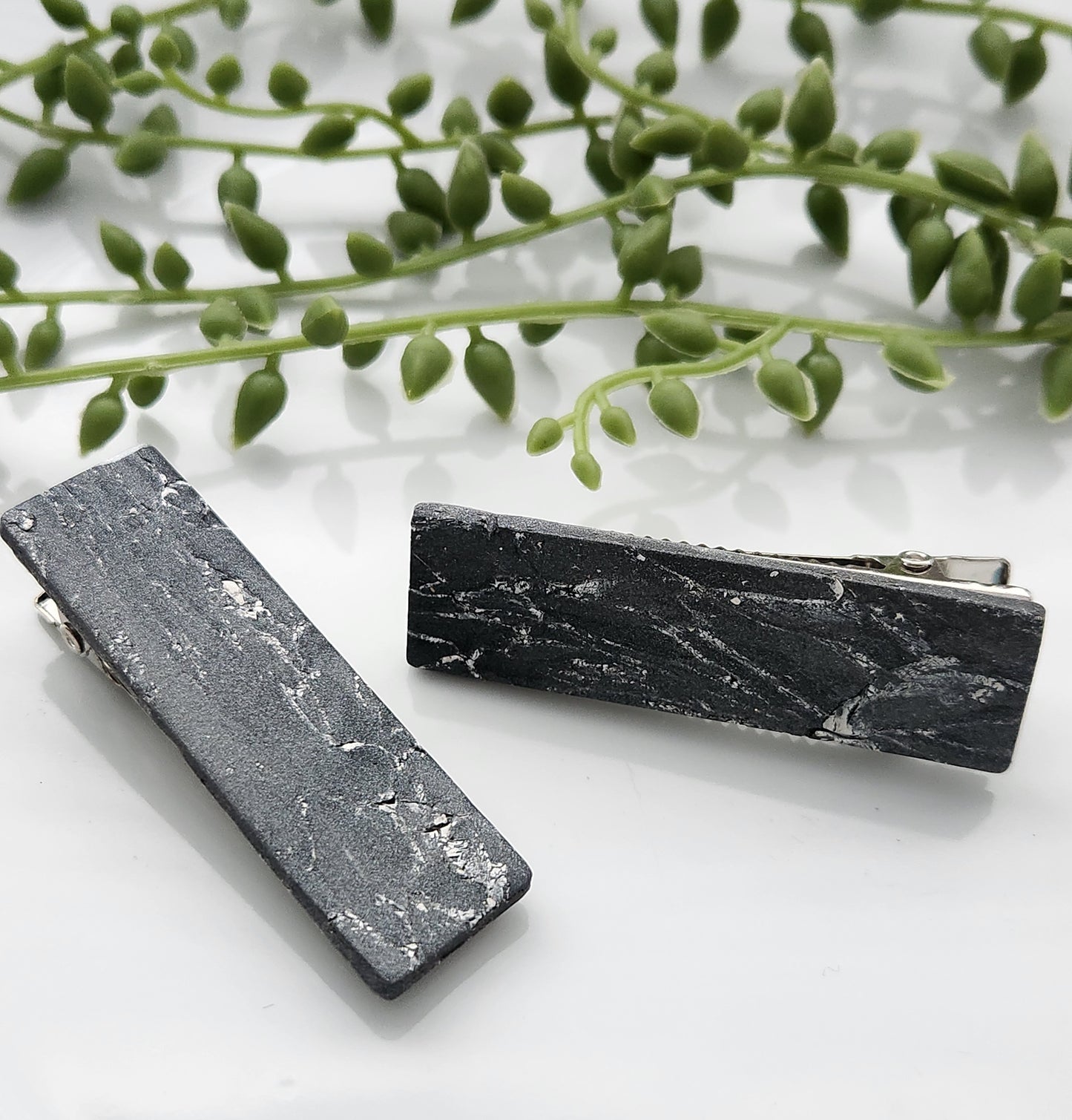 Handmade polymer clay hair clips! Super lightweight clips that bring a pop to any outfit! This beautiful clip is handmade with a polymer clay blend of gray with white colors. The hair clip is a rectangular shape with a marble stone look. It is matte and approximately 2.5" long.