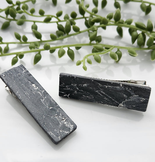 Handmade polymer clay hair clips! Super lightweight clips that bring a pop to any outfit! This beautiful clip is handmade with a polymer clay blend of gray with white colors. The hair clip is a rectangular shape with a marble stone look. It is matte and approximately 2.5" long.