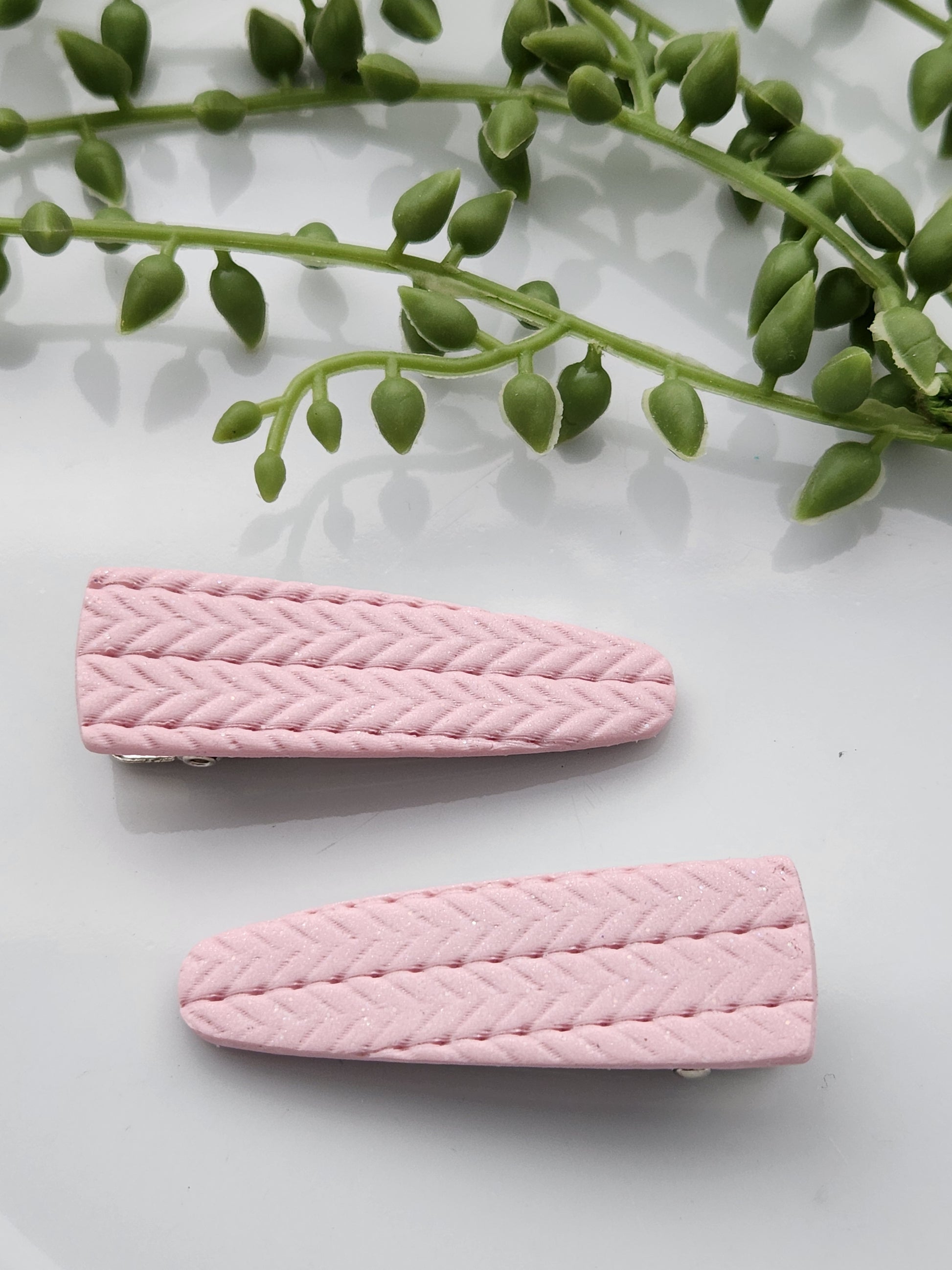 Handmade polymer clay hair clips! Super lightweight clips that bring a pop to any outfit! This beautiful clip is handmade with polymer clay in a blush pink color. It is matte and textured in a knit woven fabric look. Approximately 2.5" long.