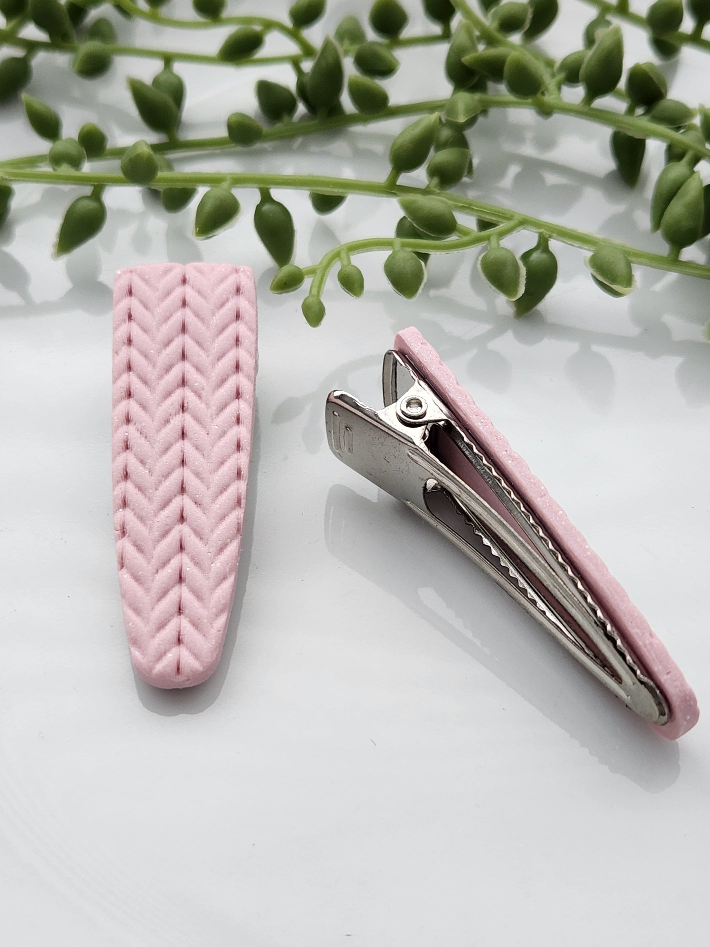 Handmade polymer clay hair clips! Super lightweight clips that bring a pop to any outfit! This beautiful clip is handmade with polymer clay in a blush pink color. It is matte and textured in a knit woven fabric look. Approximately 2.5" long.