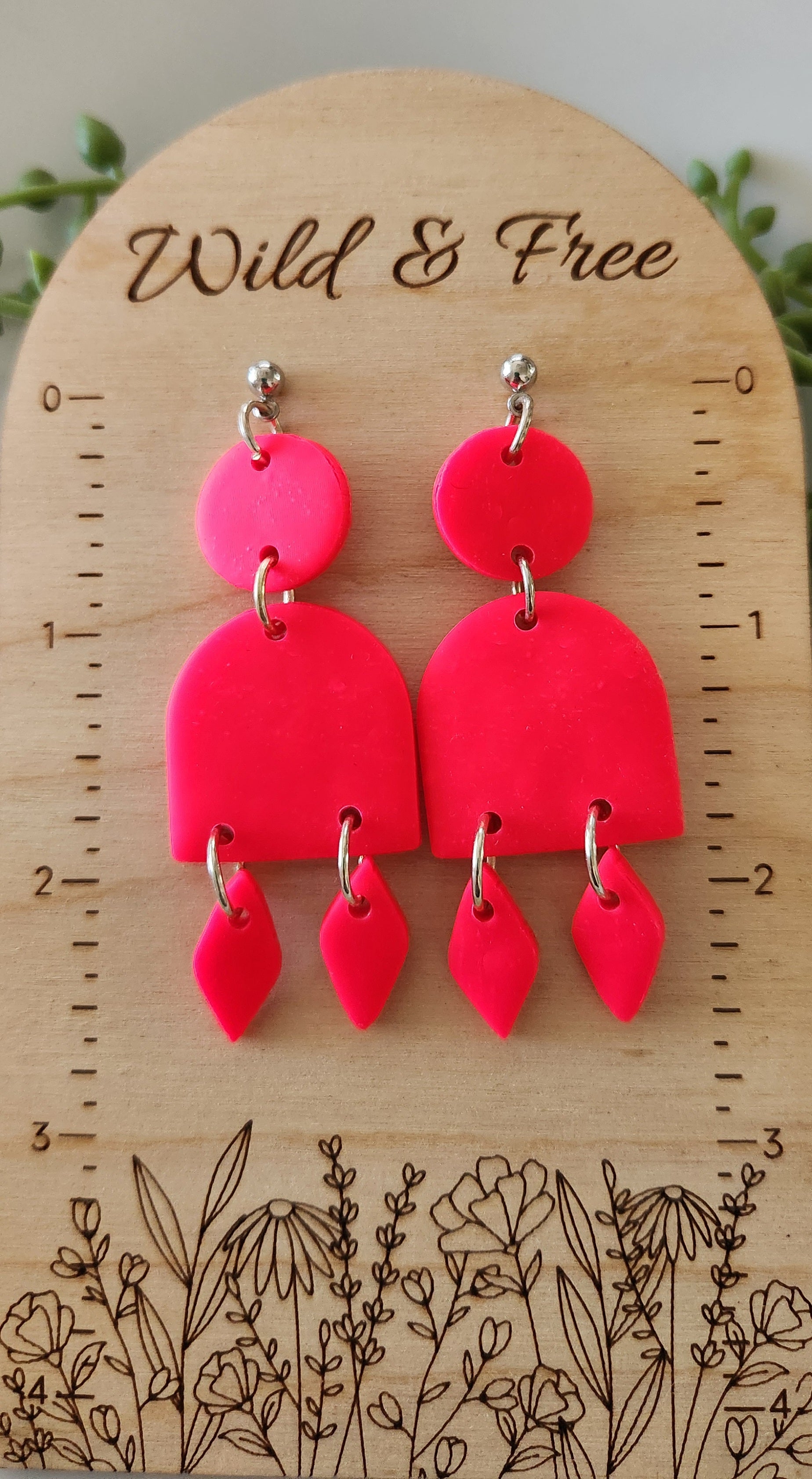 Handmade polymer clay earrings! These stunning hot pink clay earrings are sure to stand out. They consist of a clay circle with a half dome and two small diamond-shaped dangles. A circle ball stud completes this look. They are lightweight and approximately 2.5" long.