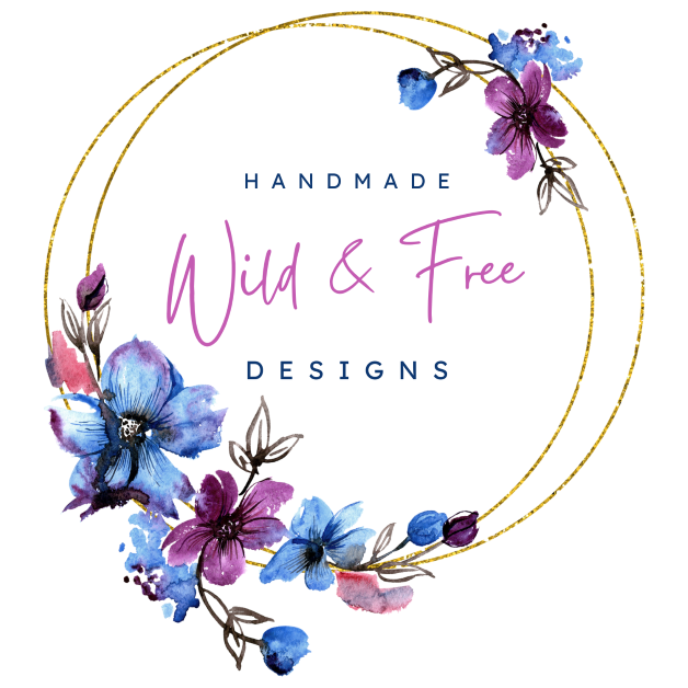 Wild & Free Handmade Designs logo. Gold circle outline with purple and blue flowers on top right and bottom left side.