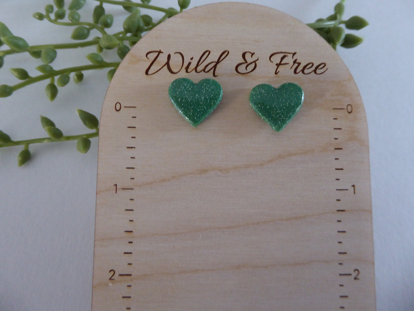 Handmade Polymer Clay Earrings! Featuring a beautiful green heart pair of studs.  Lightweight, full of shimmer and with resin for a glossy look. Approximately 1/2" long.